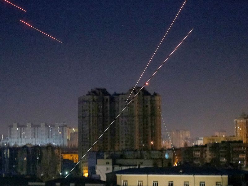 Tracers are seen in the night sky as Ukrainian servicemen fire on the drone as Russia's attack on Ukraine continues, in Kyiv. 