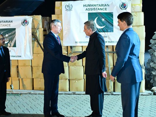 Pakistan’s Foreign Minister Shah Mehmood Qureshi hands over the consignment of relief items to the Ukrainian Ambassador Markiian Chuchuk at Nur Khan airbase in Rawalpindi on March 15, 2022. 