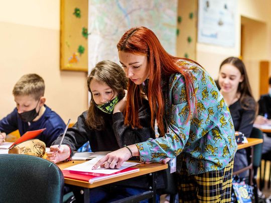 Translator and assistant Katia helps students from wartorn Ukraine in a class newly created for them at the Limanowski High School in Warsaw on March 15, 2022.  