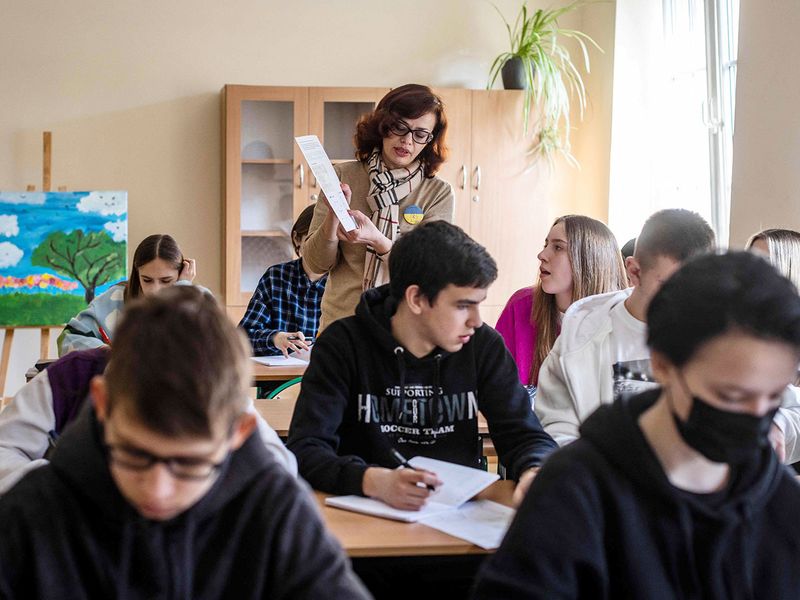 Ukrainian teacher Mariana Druchek teaches a group of Ukrainian students in a class newly created for them at the Limanowski High School in Warsaw on March 15, 2022.  