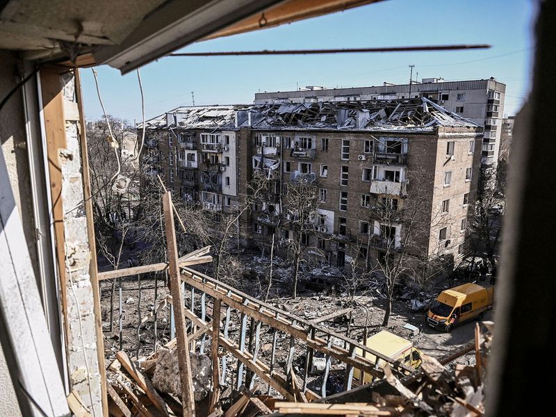 A picture shows damaged apartment buildings in a residential area after shelling in Kyiv on March 18, 2022, as Russian troops try to encircle the Ukrainian capital as part of their slow-moving offensive.  