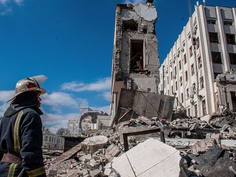 Rescuers work at the site of the National Academy of State Administration building damaged by shelling in Kharkiv, Ukraine. 