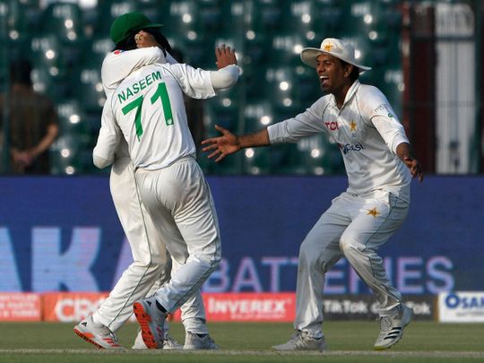 Pakistan's Naseem Shah celebrates with teammates after taking the wicket of Australia's Travis Head 