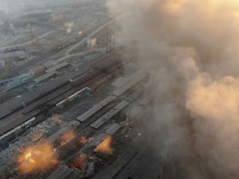 Multiple explosions and rising smoke are seen around an industrial compound, in Mariupol.  