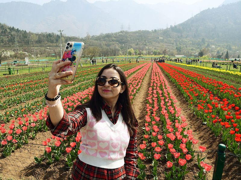 A woman takes a selfie at Tulip Garden after it reopened for the public, in Srinagar on Wednesday. 