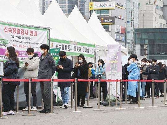 People wait in line to be tested for the COVID-19 at a virus testing centre in Seoul. 