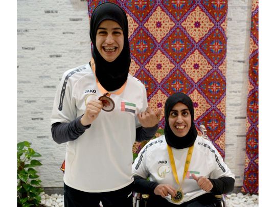 Shot putter Noura Alketbi, right, with her gold medal 