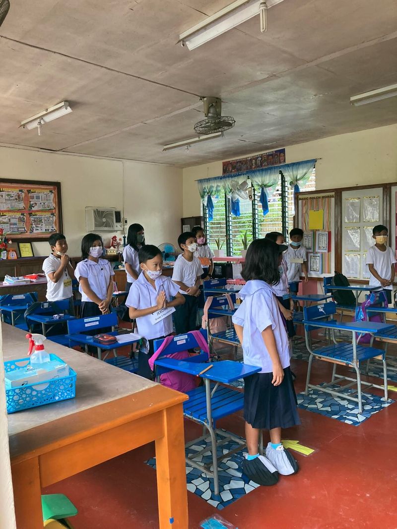 Filipino pupils show up for the morning flag ceremony for the first time Tuesday after the pandemic lockdown