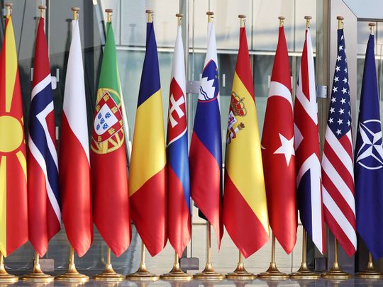 This general view shows flags of some of the participating nations ahead of an extraordinary NATO summit, on display at NATO Headquarters in Brussels on March 24, 2022.  
