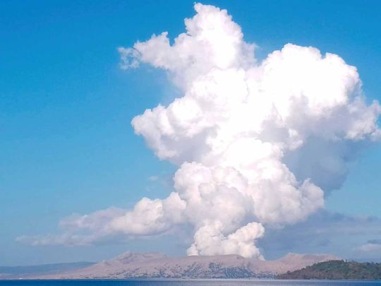Taal Volcano spews white steam and ash as seen from Balete, Batangas province, south of Manila, Philippines on Saturday March 26, 2022.