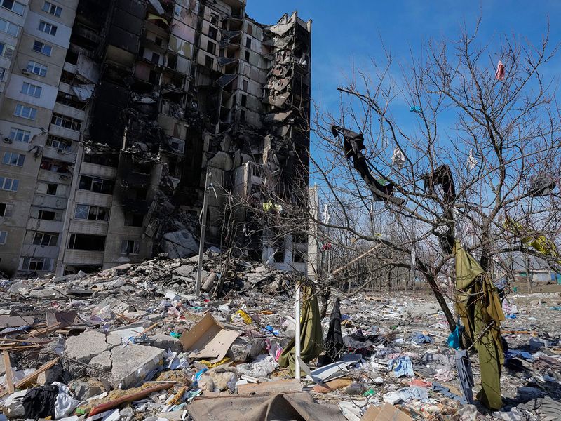 Clothes thrown by the Russian shelling from the ruined house hang on a tree in Kharkiv, Ukraine, on Saturday, March 26, 2022. 
