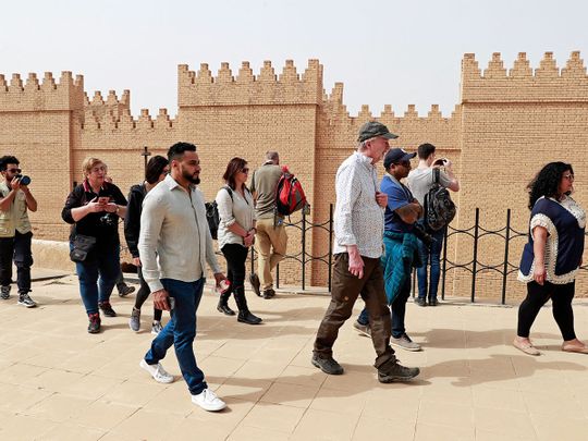Foreign tourists visit the ancient city of Babylon
