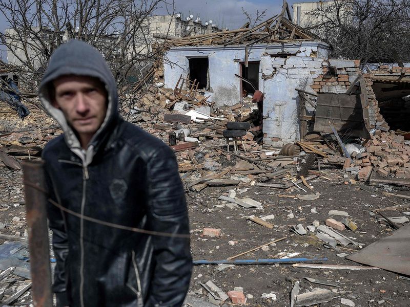 A man stands in front of a house which attacked by Russian forces in the village of Bachtanka near Mykolaiv, a key city on the road to Odessa. 