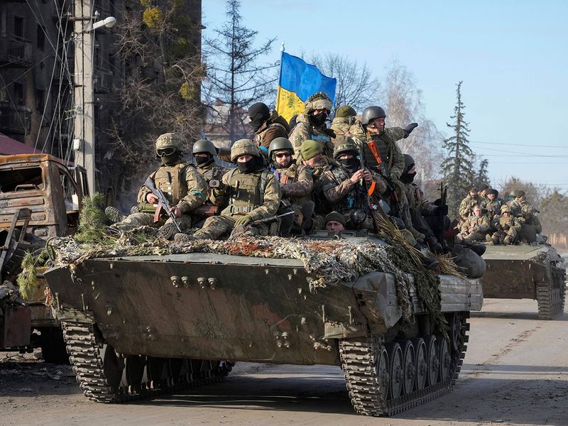 Ukrainian soldiers ride on APC through the town of Trostsyanets, some 400 km eastern of capital Kyiv, Ukraine. 