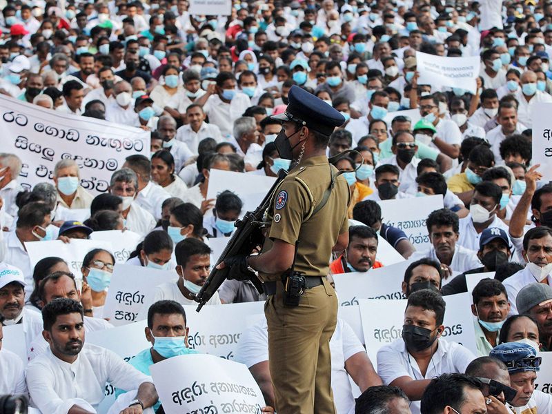 Activists from the United National Party (UNP) take part in a Satyagraha campaign to urge the government to formulate a national policy to find a way out of the ongoing economic crises, in Colombo on March 25, 2022. 