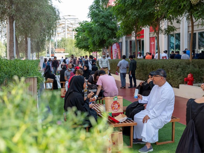 Visitors enjoy a meal outside Al Baik restaurant   