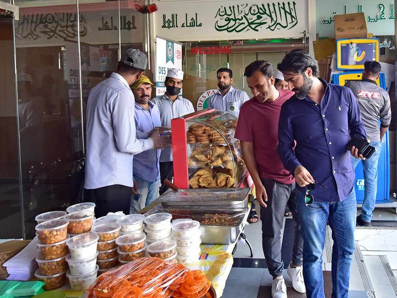 People pick up their Iftar meals from Des Pardes Restaurant in Oud Metha on the first day of Ramadan on April 2nd, 2022. 