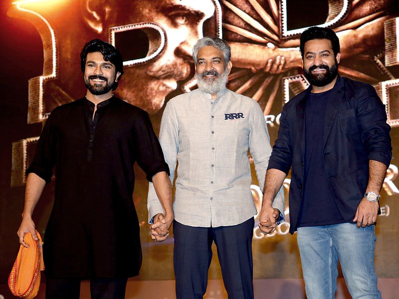 Tollywood actors NT Rama Rao Jr and Ram Charan with director SS Rajamouli pose for a picture as they celebrate the box office success of the movie 'RRR', in Mumbai on Thursday.