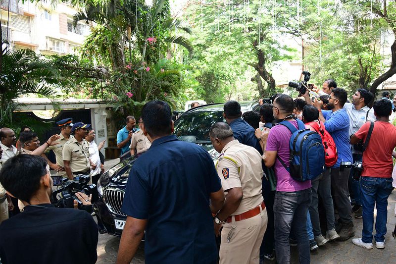 Media gather outside Bollywood actors Ranbir Kapoor and Alia Bhatt residence on the first day of their wedding ceremonies, at their residence in Mumbai on April 13, 2022