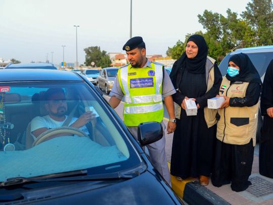 Photos: Police and volunteers across UAE distribute iftar meals to ...