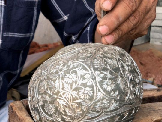 An artisan at work moulding Bidriware item-1651830257764