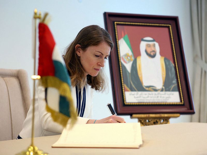 British ambassador to Kuwait Belinda Lewis writes in a book of condolences at the UAE Embassy in Kuwait.