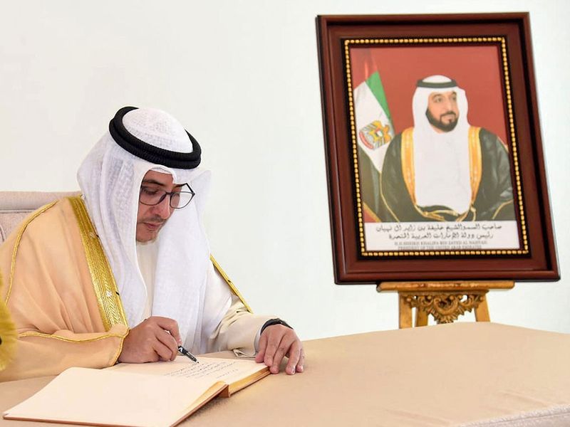 Kuwaiti Foreign Minister Sheikh Ahmed Nasser al-Mohammed al-Sabah writes in a book of condolences at the UAE Embassy in Kuwait City.