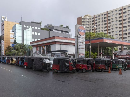Three-wheelers line up for fuel at a gas station in Colombo, Sri Lanka, on Monday, May 16, 2022. 