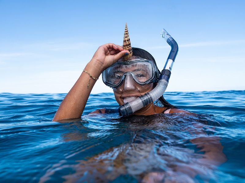Diving snorkelling in the sea being playful