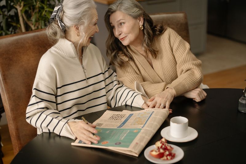 Mature women playing crossword 