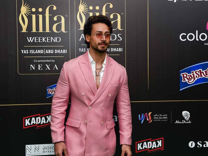 Bollywood action hero Tiger Shroff makes a statement in pastel pink at the IIFA Rocks green carpet   