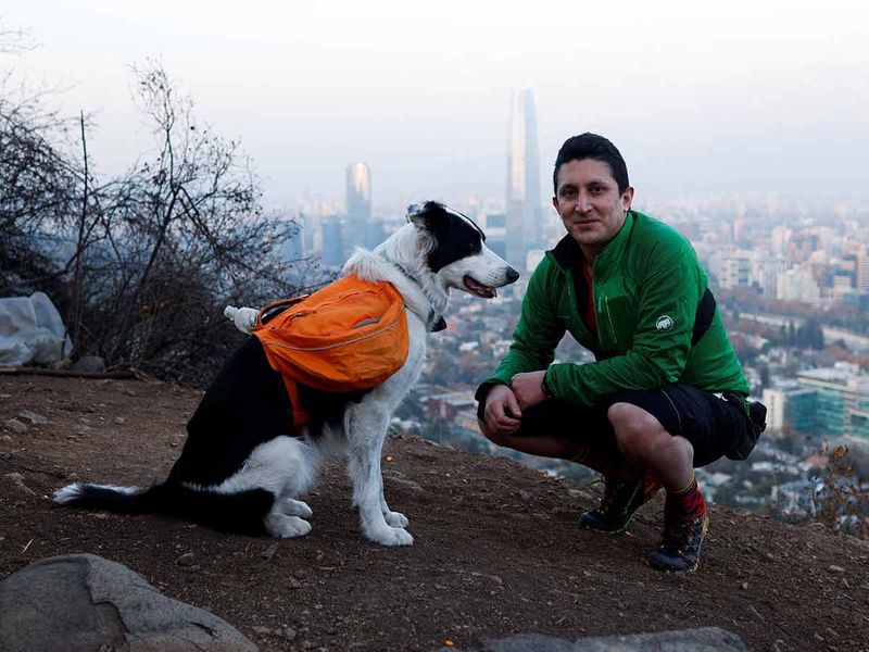 Gonzalo Chiang and his dog Sam are pictured as they search garbage for collecting and keeping clean the metropolitan park (Parquemet) of Santiago, Chile. 