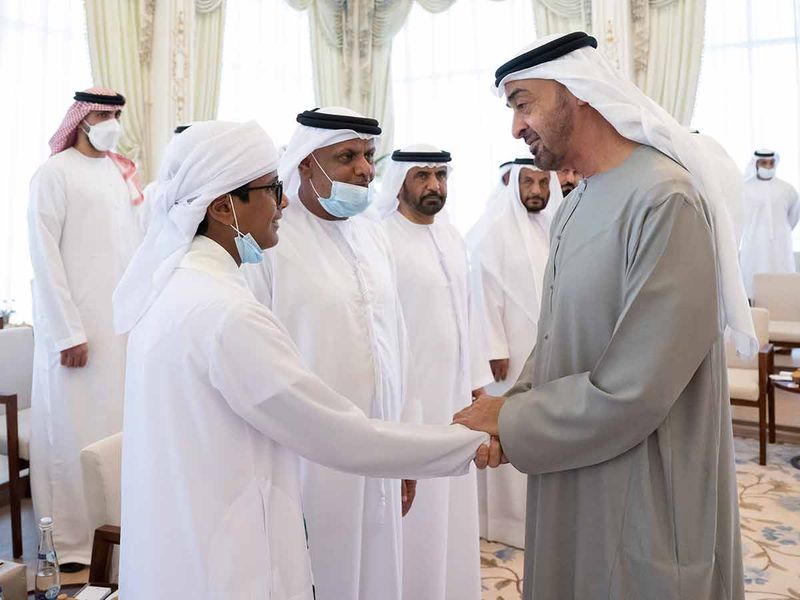 Sheikh Mohamed greets Emirati student Khamis Al Junaibi. 