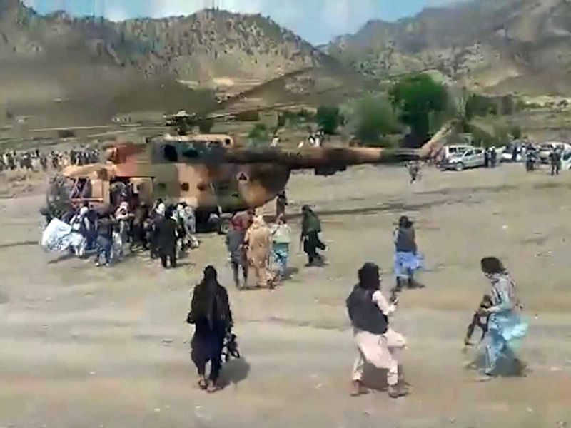 Taliban fighters secure a government helicopter to evacuate injured people in Gayan district, Paktika province, Afghanistan. 