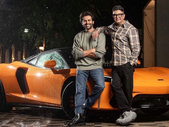 Actor Kartik Aaryan and producer Bhushan Kumar with the McLaren GT