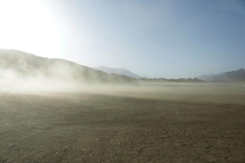 Dust blows through the dried basin of the La Boca dam in Santiago, Mexico. 