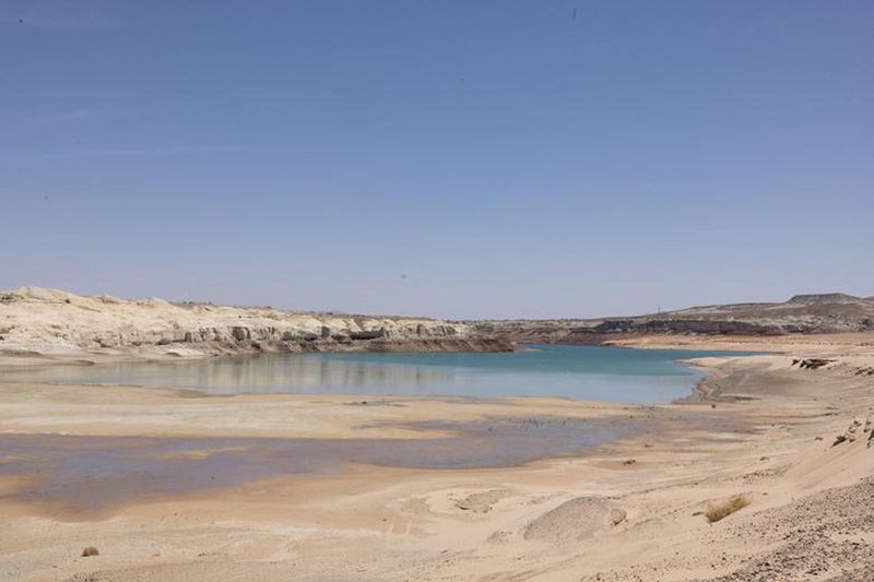 Water recedes near Lone Rock Beach, a popular recreational area that used to be underwater, at Lake Powell, in Big Water, Utah.  
