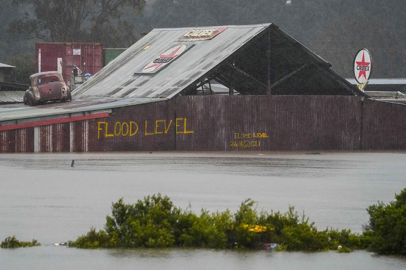 Flood waters surround an industrial property in Londonderry on the outskirts of Sydney, Australia, Monday, July 4, 2022. More than 30,000 residents of Sydney and its surrounds have been told to evacuate or prepare to abandon their homes on Monday as Australia's largest city braces for what could be its worst flooding in 18 months. 