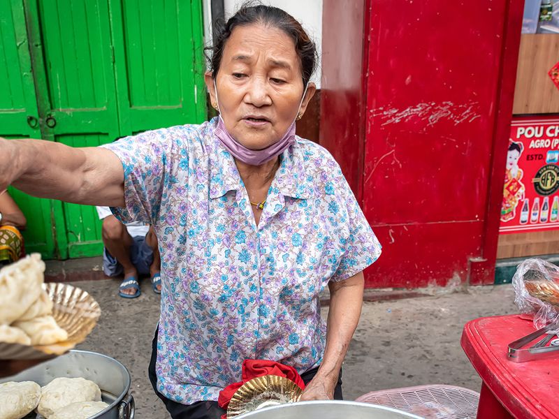 A unidentified woman selling Chinese Breakfast at Teretti Bazaar, Kolkata, India on April 2021