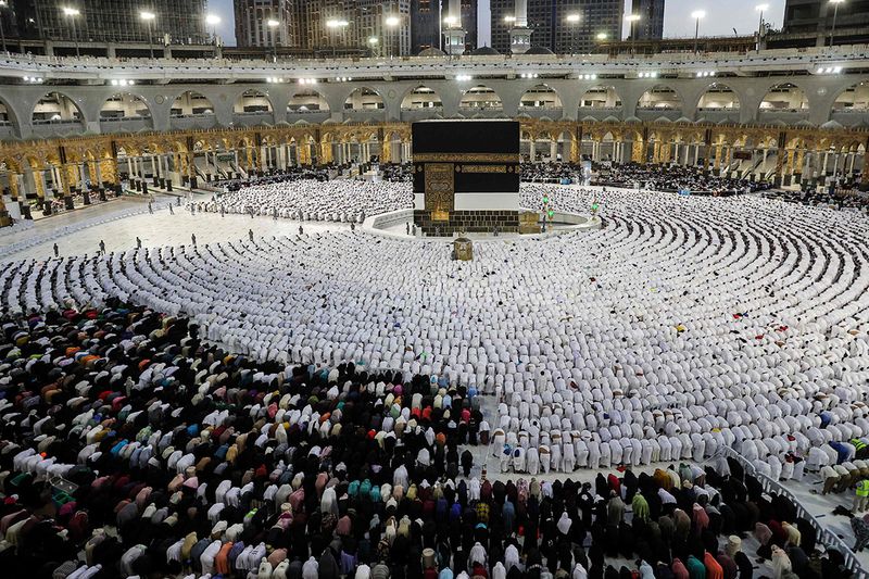Muslim worshippers and pilgrims (white) pray around the Kaaba, Islam's holiest shrine, at the Grand Mosque in Saudi Arabia's holy city of Mecca.