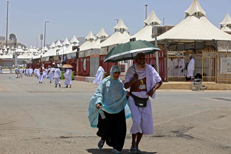 Pilgrims arrive to their camp in Mina near the Saudi holy city of Mecca on July 7, 2022 during the annual Hajj pilgrimage. 