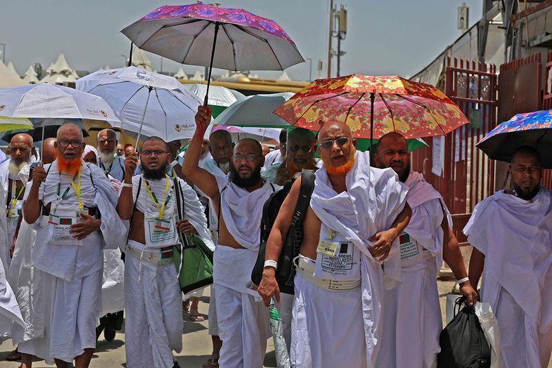 Pilgrims arrive to their camp in Mina near the Saudi holy city of Mecca on July 7, 2022 during the annual Hajj pilgrimage.