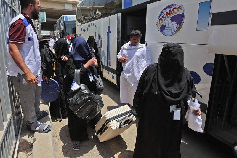 Women pilgrims arrive to their camp in Mina near the Saudi holy city of Mecca on July 7, 2022 during the annual Hajj pilgrimage.