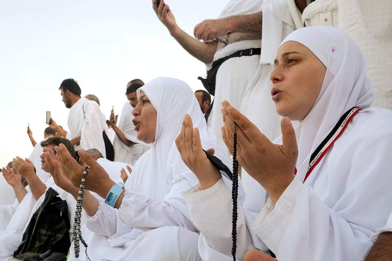 Muslim pilgrim pray on the rocky hill known as the Mountain of Mercy, on the Plain of Arafat, during the annual hajj pilgrimage, near the holy city of Mecca, Saudi Arabia, Friday, July 8, 2022. One million pilgrims from across the globe amassed on Thursday in the holy city of Mecca in Saudi Arabia to perform the initial rites of the hajj, marking the largest Islamic pilgrimage since the coronavirus pandemic upended the annual event, a key pillar of Islam