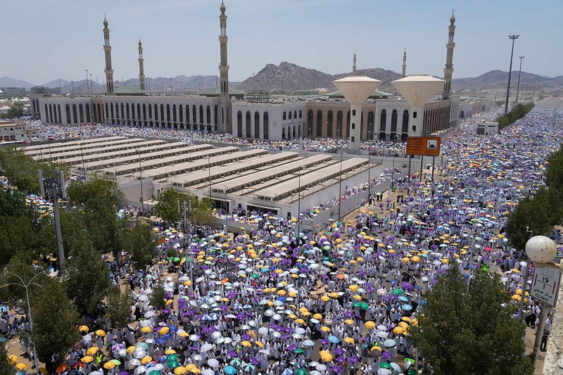 Muslim pilgrims move on their way to perform Friday Prayers at Namira Mosque in Arafat, on the second day of the annual hajj pilgrimage, near the holy city of Mecca, Saudi Arabia, Friday, July 8, 2022