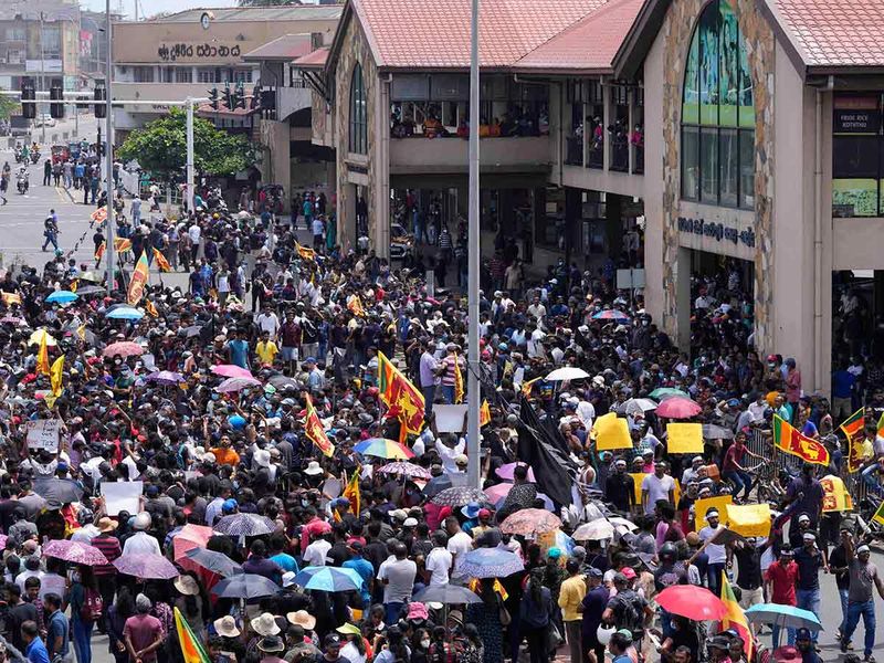 Anti Government protesters shout slogans outside the Galle International Cricket Stadium during the second day of the second test cricket match between Australia and Sri Lanka in Galle, Sri Lanka, Saturday, July 9, 2022. 