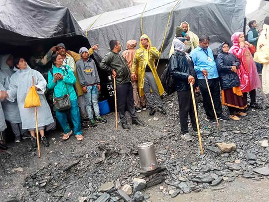 Hindu devotees are seen stranded after a cloudburst near the base camp of the holy cave shrine of Amarnath in south of Kashmir Himalayas, in India. 