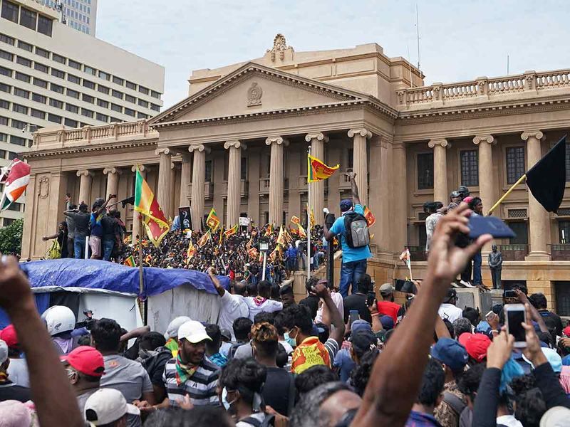 Protesters, many carrying Sri Lankan flags, gather outside the presidents office in Colombo, Sri Lanka, Saturday, July 9, 2022. Sri Lankan protesters stormed President Gotabaya Rajapaksa's residence and nearby office on Saturday 