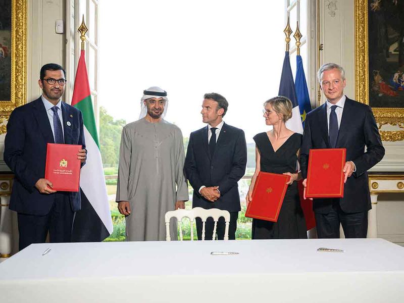 Sheikh Mohamed (2nd left) and Emmanuel Macron (3rd left), stand for a photograph after an MOU signing ceremony, at the Versailles Grand Trianon. 