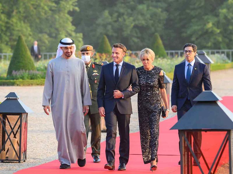 Sheikh Mohamed arrives for a dinner reception hosted by Emmanuel Macron (2nd left), at the Versailles Grand Trianon. Seen with Mrs Brigitte Macron (3rd left) and Sheikh Mansour bin Zayed Al Nahyan (right).